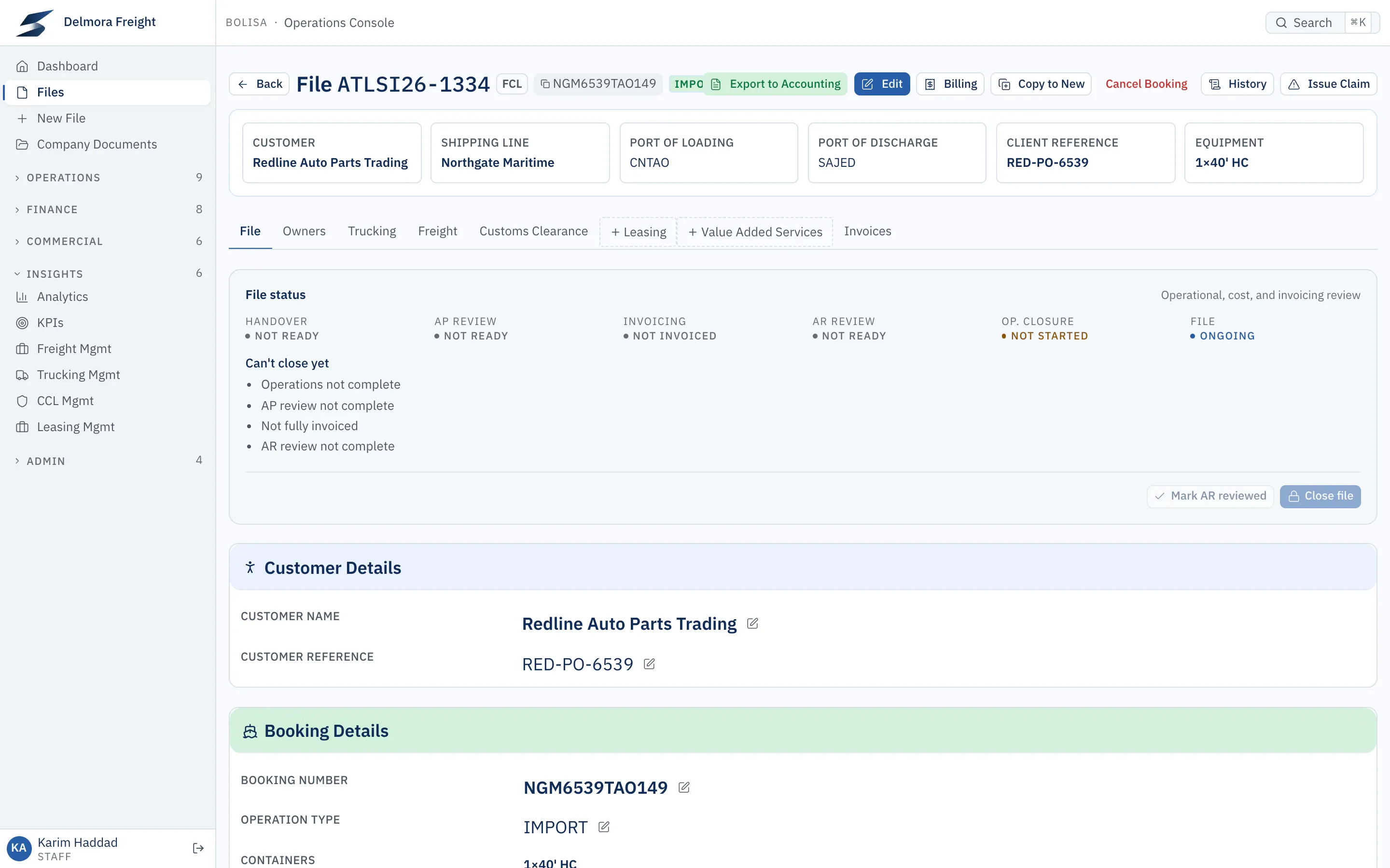 An import shipment file opened from the drilldown. Its status panel shows the file can’t close yet and lists why: operations, cost review, invoicing and customer review are not complete.